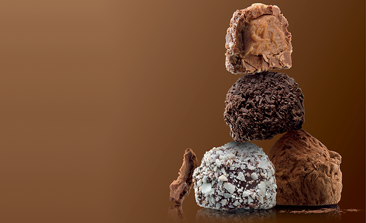 stacked-truffles-on-brown-background