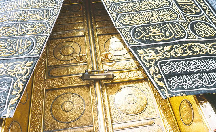 MECCA, SAUDI ARABIA - MAY 01 2018: The golden doors of the Holy Kaaba closeup, covered with Kiswah. Massive lock on the doors. Entrance to the Kaaba in Masjid al Haram; Shutterstock ID 1087638440; Purchase Order: -