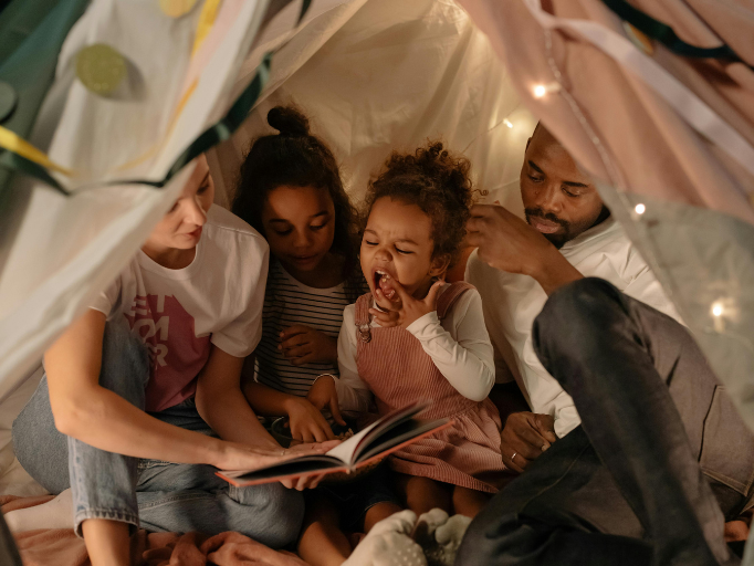 picture of family reading books for their kids.