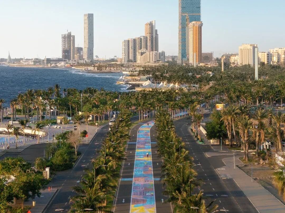 Top view of Jeddah’s walkways along the sea, lined with palm trees